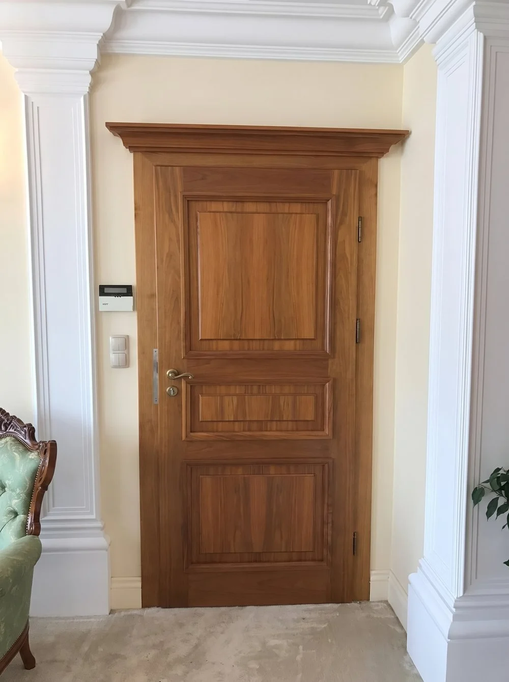 Solid timber door of panelled construction, a classical interior