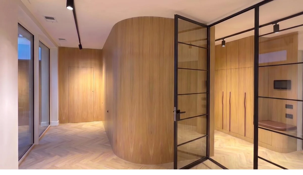 Curved wall system with loft-style doors, natural oak veneer